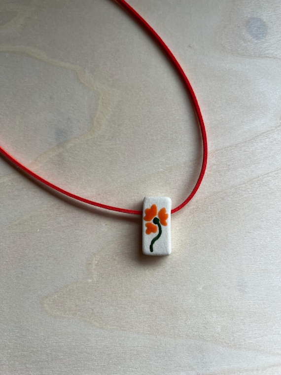 Ceramic orange flower bead necklace with faux suede cord