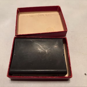 May include: A red box with a black ink pad inside. The ink pad is in a red box with a white interior.