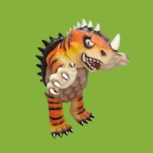 May include: A cartoonish, orange and black dinosaur figurine with a white horn and teeth. The dinosaur has a spiky back and is set against a green background. The dinosaur's claws are white.
