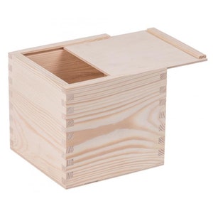 May include: A natural wood box with a hinged lid. The box is made of unfinished pine and has a simple, rectangular shape.