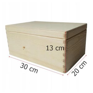 May include: A rectangular wooden box, measuring 30 cm long, 20 cm wide, and 13 cm high. The box is constructed from light-colored wood and features dovetail joints at the corners. The lid sits flush on top.