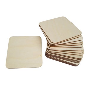 May include: A stack of 15 unfinished square wooden coasters, each measuring approximately 3.5 inches by 3.5 inches. The coasters are made of natural wood and have a smooth, sanded surface.