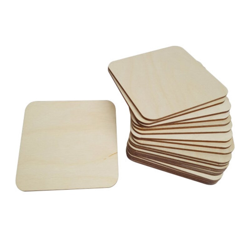May include: A stack of 15 unfinished square wooden coasters, each measuring approximately 3.5 inches by 3.5 inches. The coasters are made of natural wood and have a smooth, sanded surface.