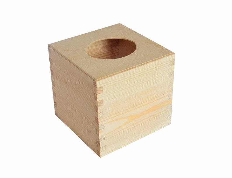 May include: A plain wooden tissue box cover with a square shape and a round opening on the top.