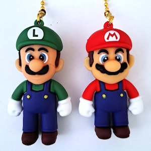 May include: Two plastic figurines of Mario and Luigi characters from the Super Mario Bros. video game series. The figurines are attached to gold chains and are designed to be used as fan pull chains for ceiling fans.