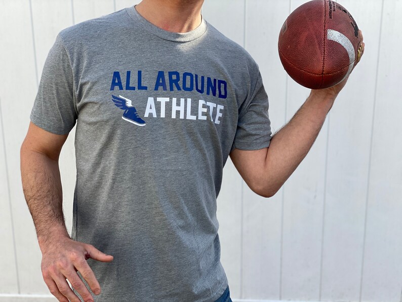 May include: A gray heather t-shirt with a blue and white graphic of a winged running shoe and the text "ALL AROUND ATHLETE".