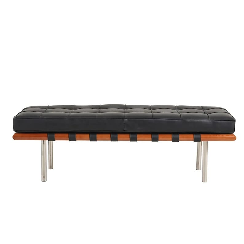 May include: A black leather bench with a wood frame and chrome legs. The bench has a tufted seat and a slatted base.