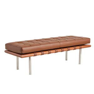 May include: A brown leather bench with a wooden frame and metal legs. The bench has a tufted seat and a woven leather strap design.