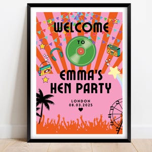 May include: A framed poster with a pink background and a retro design. The poster reads "Welcome to Emma's Hen Party" with a record, boombox, and other party-themed graphics. The date and location are also included.