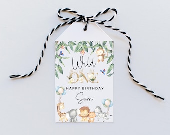 May include: A white tag with a black and white string attached. The tag has a jungle theme with animals and the text "Wild One" and "Happy Birthday Sam".