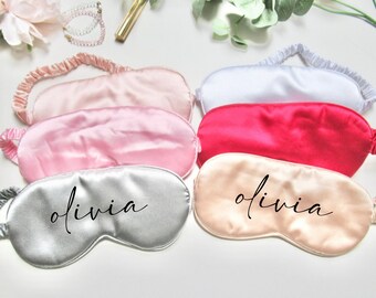 May include: Five satin sleep masks in different colors, including pink, white, red, gray, and beige. The masks are all personalized with the name "olivia" in black script.