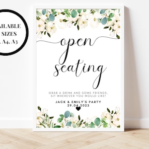 May include: White and green floral wedding sign with the text "open seating" and the message "Grab a drink and some friends. Sit wherever you would like!"  Jack & Emily's Party 29.04.2023.