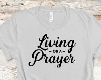 May include: A gray t-shirt with the text "Living on a Prayer" in black.