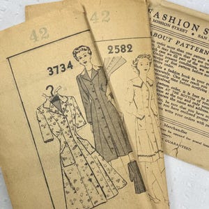May include: Vintage sewing patterns with illustrations of dresses and coats. The patterns are on aged paper, with text including "Fashion Service" and pattern numbers. The designs are from the mid-20th century.