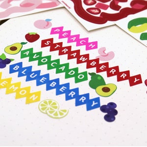 May include: A set of colorful fruit and vegetable stickers with the names of each fruit or vegetable written on them. The stickers are arranged in a rainbow pattern, with the colors of the rainbow corresponding to the colors of the fruits and vegetables. The stickers are on a white background with small white dots.