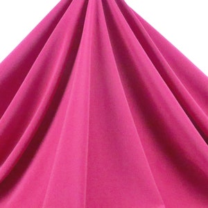 May include: A vibrant pink fabric draped in soft folds, showcasing its smooth texture and rich color.