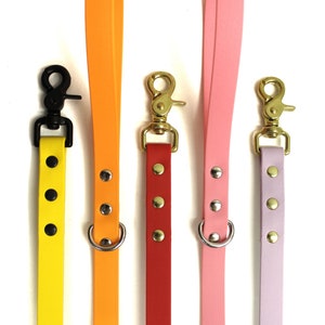 Puede incluir: Cuatro correas para perros en diferentes colores: amarillo, naranja, rojo y rosa. Cada correa tiene un anillo de metal y un broche de metal. Las correas est&aacute;n hechas de un material liso y similar al caucho.