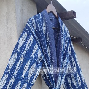 May include: A blue cotton robe with a white fish print. The robe has a tie belt and is made of kantha stitching.