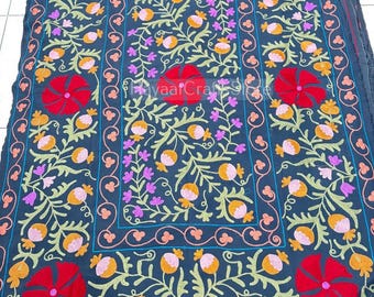 May include: A dark charcoal fabric textile featuring intricate floral embroidery in vibrant red, orange, pink, and light green. The design includes large red blossoms and smaller rounded buds connected by winding stems, with the text HayaaCraftStore.