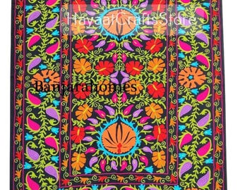 May include: A black rectangular textile featuring vibrant multi-colored floral and paisley embroidery in orange, red, pink, purple, and blue. The fabric displays the text HayaalCraftsStore and Banjarahomes. The design includes a central motif.