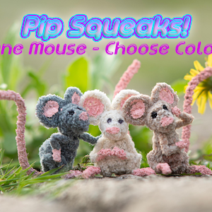 May include: Three crocheted mouse toys in gray, white, and brown with pink ears and noses. The toys are sitting on a bed of green grass with a dandelion in the background. The text "Pip Squeaks! One Mouse - Choose Color" is displayed above the toys.