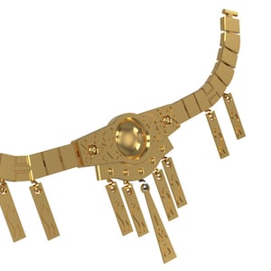 May include: A gold necklace with a large circular pendant and multiple dangling charms. A gold cylindrical object with intricate designs is also pictured.