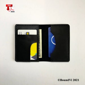 May include: A black leather wallet with two card slots and a cash pocket. The wallet is open and shows a credit card, a gift card, and cash.