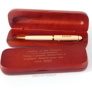 May include: A wooden pen with gold accents and the word "DAD" engraved on the barrel, presented in an open, dark-stained wooden case. The case lid has an inscription: "Father of the Groom...Love, Eddie."