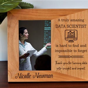May include: A wooden picture frame with a photo of a data scientist. The frame has the text "A truly amazing DATA SCIENTIST is hard to find and impossible to forget." The name "Nicolle Newman" is also engraved on the frame.