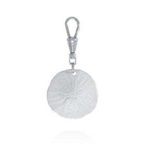 May include: Silver sand dollar keychain with a silver lobster clasp.