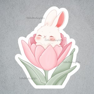 May include: A white bunny with pink ears is nestled inside a pink tulip. The tulip has green leaves and a stem.
