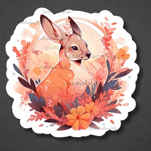 K&ouml;nnte beinhalten: Ein Aufkleber mit einem niedlichen Cartoon-Rehkitz mit orange-braunem Fell, umgeben von rosa, orange und blauen Blumen. Das Rehkitz schaut nach rechts im Bild.