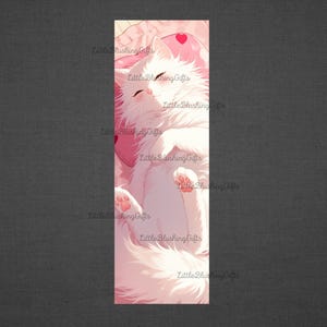 May include: A white cat with pink paws sleeps on a pink pillow with a heart on it. The cat is curled up and its eyes are closed. The background is a soft pink.