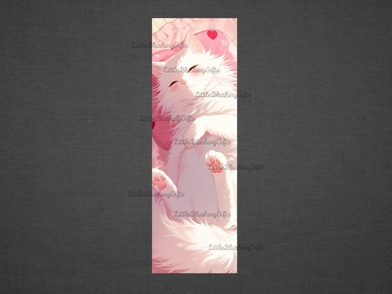 May include: A white cat with pink paws sleeps on a pink pillow with a heart on it. The cat is curled up and its eyes are closed. The background is a soft pink.