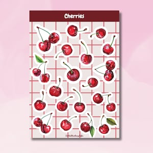 May include: A sheet of stickers featuring red cherries with green leaves. The stickers are arranged in a grid pattern on a white background with a red border. The text "Cherries" is printed in pink at the top of the sheet.