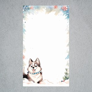 May include: A cute cartoon husky dog wearing a blue and white striped scarf, standing in the snow with a snowy background and a floral border.