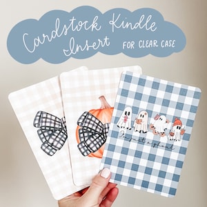 May include: Three printable cards with a blue and white gingham pattern. The first card features a pumpkin with a black and white bow. The second card features a black and white bow. The third card features a line of ghosts with the text "I'm just a ghoul".
