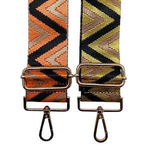 May include: Two adjustable straps with gold-tone hardware and a geometric pattern. One strap is orange, black, and gold, and the other is green, black, and gold.