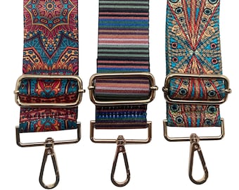 May include: Three colorful patterned fabric straps with gold metal buckles and clasps. The straps are in a variety of patterns, including a paisley design, a striped design, and a geometric design.