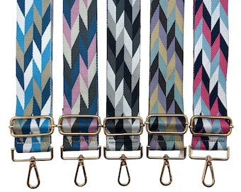 May include: Five different patterned fabric straps with gold metal hardware. The straps are all the same length and width, and they have a chevron pattern. The straps are in various colors, including blue, pink, gray, and teal.