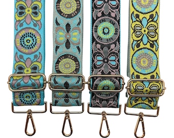 May include: Four colorful patterned fabric straps with gold metal clasps and swivel hooks. The straps are turquoise, gray, black, and yellow with geometric and floral designs.