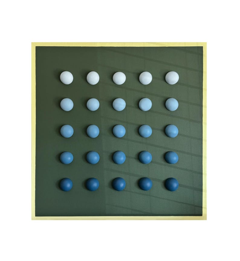 May include: A square artwork featuring a grid of 20 spherical objects. The spheres transition in color from white to deep blue, arranged on a dark green background. The artwork is framed with a gold border.