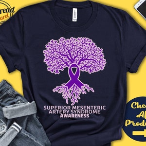 May include: A navy blue t-shirt with a purple ribbon tree design. The text "Superior Mesenteric Artery Syndrome Awareness" is printed below the tree.