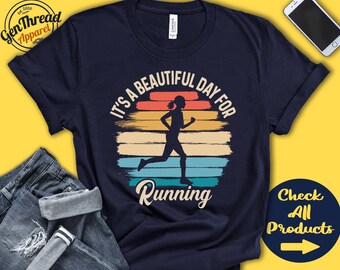 May include: A navy blue t-shirt with a vintage-style graphic of a runner with the text "It's a beautiful day for running".