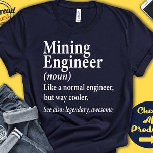 May include: A navy blue t-shirt with white text that reads "Mining Engineer (noun) Like a normal engineer, but way cooler. See also: legendary, awesome".