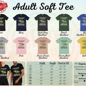 May include: Adult soft t-shirt featuring a green alligator with the text "Crocodiles are awesome, I am awesome, Therefore I am a crocodile". The shirt is available in 10 colours: black, navy, dark grey heather, forest heather, blue heather true royal, grey athletic heather, pink, prism peach heather, prism mint heather, and yellow. The size chart shows width, length, and chest to fit measurements in inches. The shirt is described as true to size, comfortable, soft, and flattering. The thickness is described as light and the softness is described as rough to soft.
