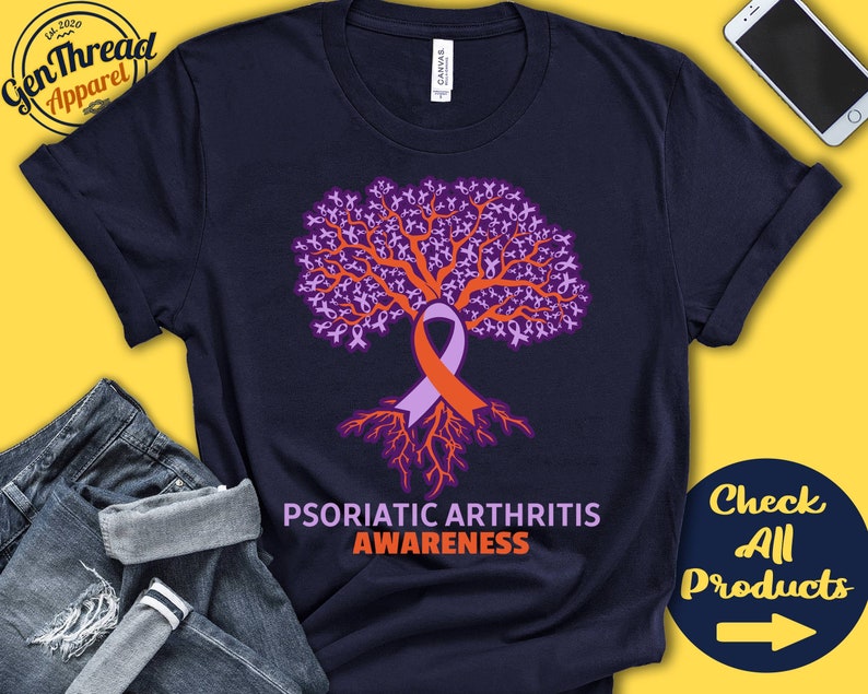 May include: Navy blue t-shirt with a purple and orange tree design. The tree is made up of many small ribbons. The text "Psoriatic Arthritis Awareness" is printed below the tree.