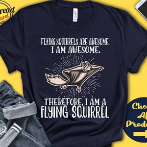 May include: A navy blue t-shirt featuring a white graphic of a flying squirrel. The text on the shirt reads "Flying squirrels are awesome. I am awesome. Therefore, I am a flying squirrel."