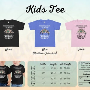 May include: A black, blue, and pink kids' t-shirt with a jumping spider graphic and the text "Jumping spiders are awesome. I am awesome. Therefore, I am a jumping spider." The shirt is available in sizes 2-5 years and comes in a variety of colors. The size chart shows the width, length, and weight range for each size.