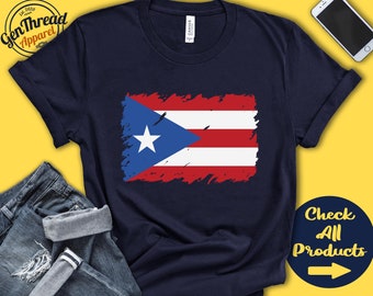 May include: A navy blue t-shirt with a distressed Puerto Rican flag design. The flag is red, white, and blue with a white star in the blue triangle. The text "Check All Products" with a right arrow is in the bottom right corner of the image.
